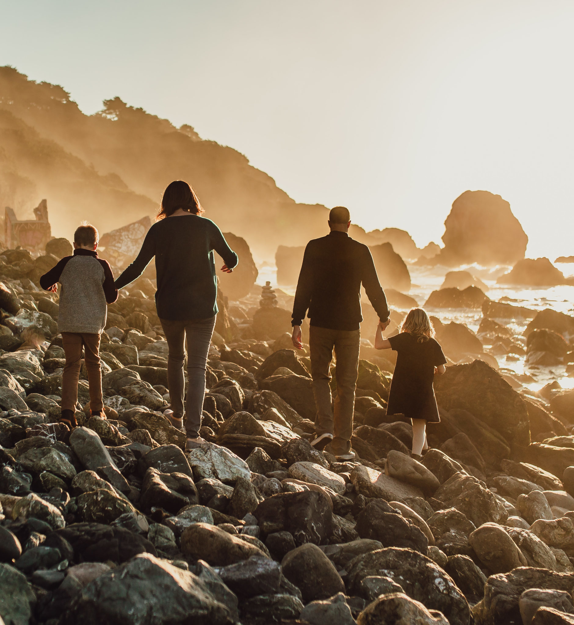 San Francisco family walks down mile rock beach at sunset