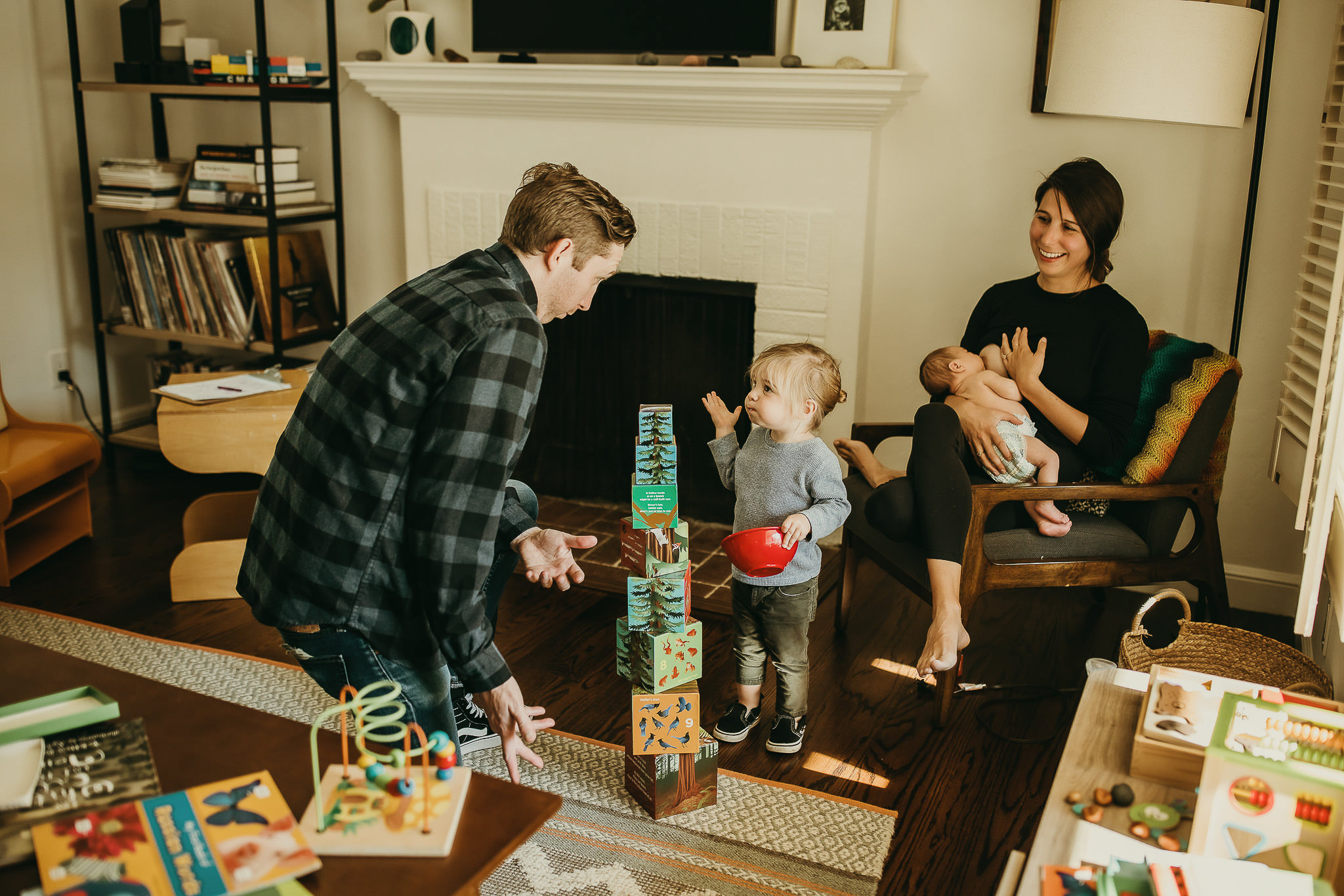 Photo of family playing at in home newborn session by Ashley Kaplan Photography